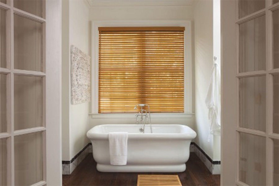 faux wood blinds above a tub