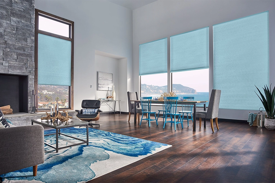 Smart motorized window shades are perfect on tall windows in your Raleigh home. Blue motorized shades on tall living room windows